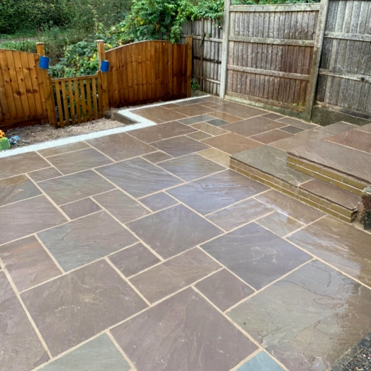 Indian stone patio with brick-edged steps