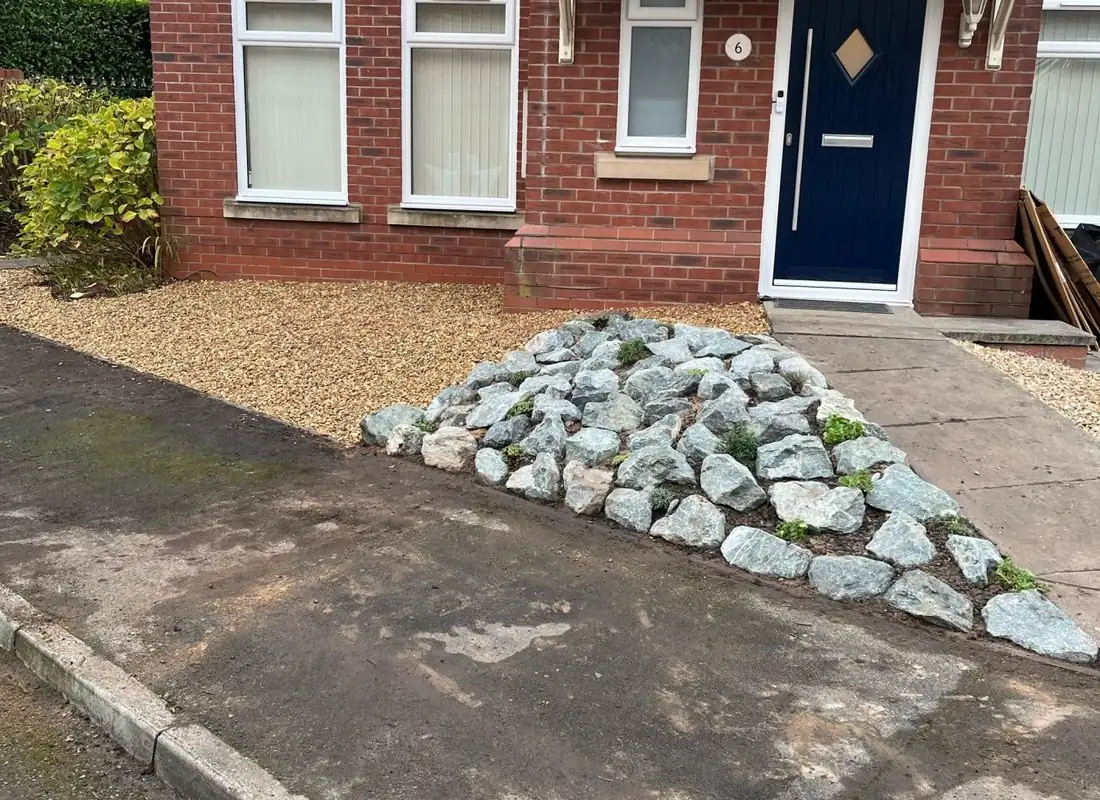 Front garden with gravel, rockery and a paved path